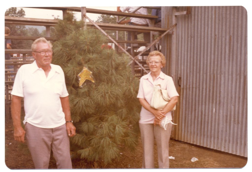 John and Dot Wyckoff standing next to pine tree