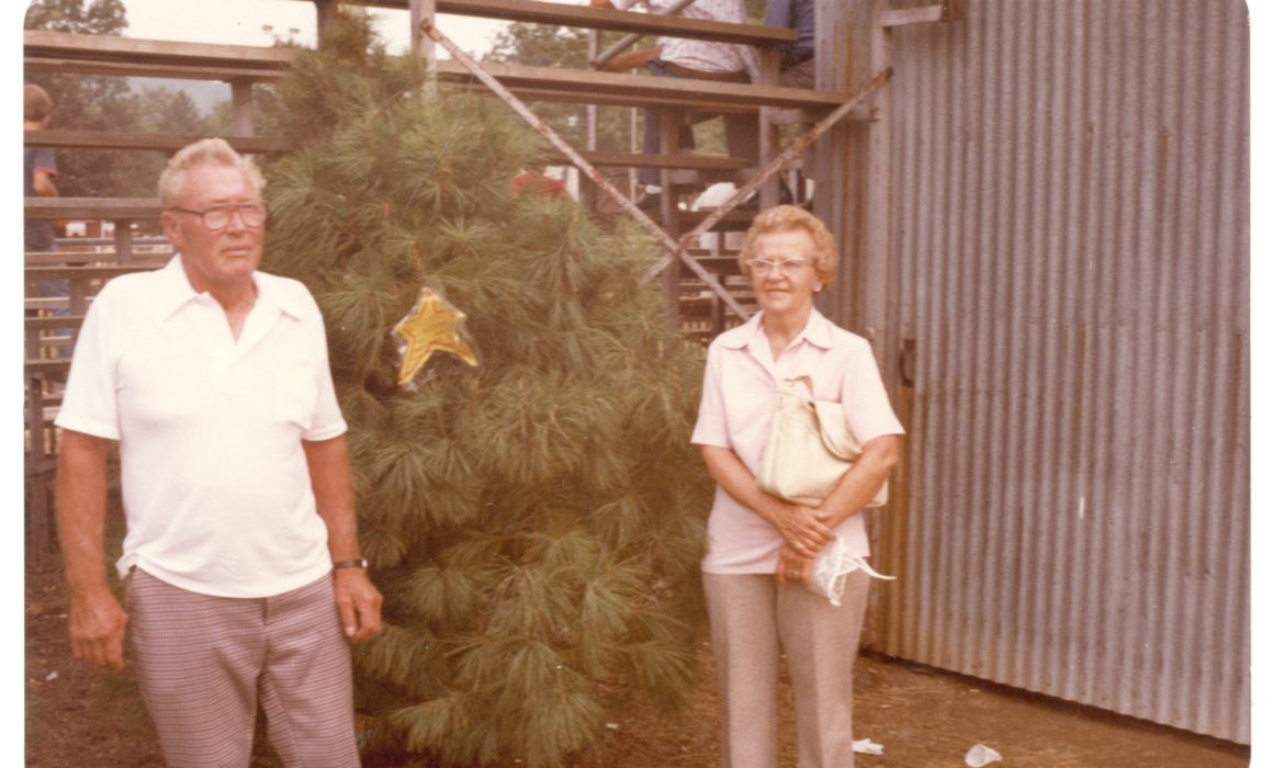 John and Dot Wyckoff standing next to pine tree