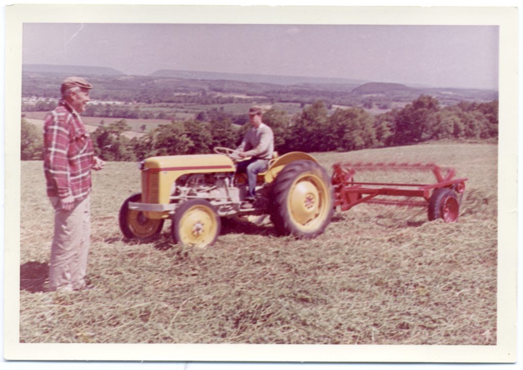 old photo of farmer making hay